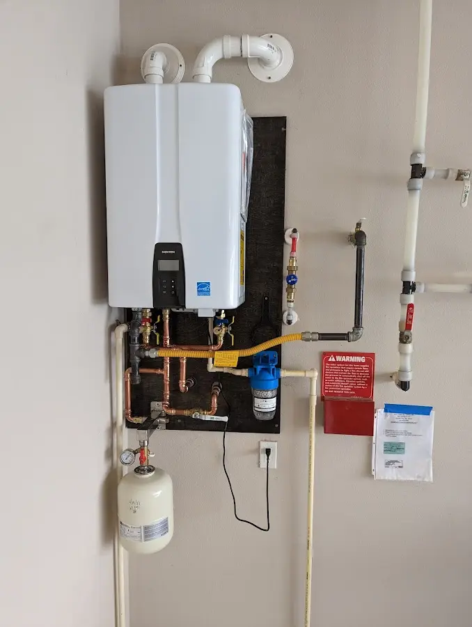 Professional plumber installing copper piping in a Ellsworth home